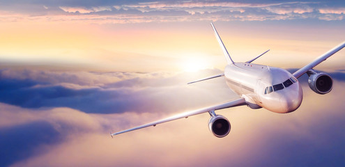 Wall Mural - passengers commercial airplane flying above clouds