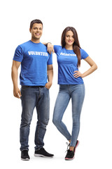 Young man and woman volunteers in blue t-shirts posing