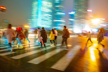 Abstract Background Of People Across The Crosswalk At Night In Shanghai, China.