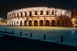 Panorama of illuminated Roman amphitheater in French city of Nimes
