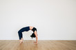 © murtazadaud/Stocksy - A yoga teacher performing a human arch