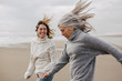 © Bonninstudio/Stocksy - Active senior woman and her daughter enjoying on the beach in winter.
