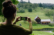 © Raymond Forbes LLC/Stocksy - Woman Taking Landscape Photos on her Smartphone