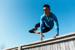 © Santi Nunez/Stocksy - Young asian man practicing parkour in the city.