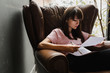 © MEM Studio/Stocksy - Woman reading paperwork