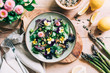 © Nata_a Mandi_/Stocksy - Delicious fresh salad with asparagus, english daisy and pansy