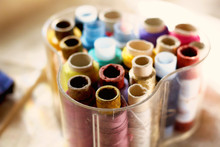Colored Threads In Transparent Plastic Sewing Box On Fabric Canvas. Tools For Craft And Hobby