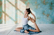 © Julia Volk/Stocksy - Young woman practicing yoga in studio