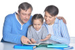 © aletia2011 - Parents with daughter reading books on white background