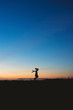 © Cavan Images - Silhouette of a young girl skipping at sunset near San Diego, CA