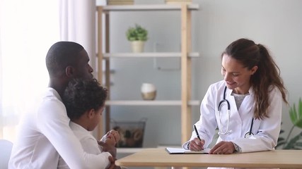 Wall Mural - Female caucasian doctor listening to african father of little patient