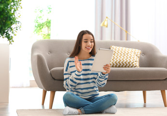 Poster - Woman using tablet for video chat in living room