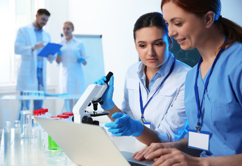 Poster - Group of scientists working in modern chemistry laboratory