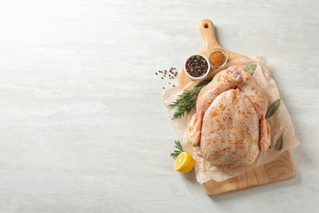 Sticker - Board with raw spiced turkey and ingredients on light background, top view. Space for text