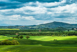 Fototapeta Pokój dzieciecy - Tuscany spring, rolling hills and windmill on sunset. Rural landscape. Green fields. Italy, Europe