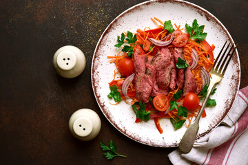 Vegetable salad with roast beef. Top view with copy space.