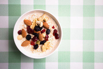 Healthy breakfast fresh granola muesli with milk and nuts