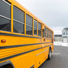 Wall Mural - Square Exterior view of a yellow school bus with a red stop sign and signal lights