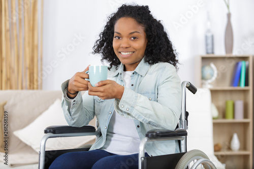 disabled woman in wheelchair drinking coffee