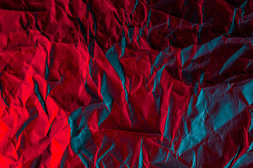 Poster - Texture of crumpled black paper. Close up black background of crumpled cardboard under color red and blue studio light