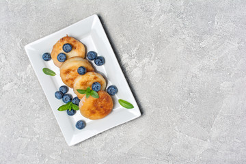 Wall Mural - Cottage cheese pancakes with blueberries on white plate