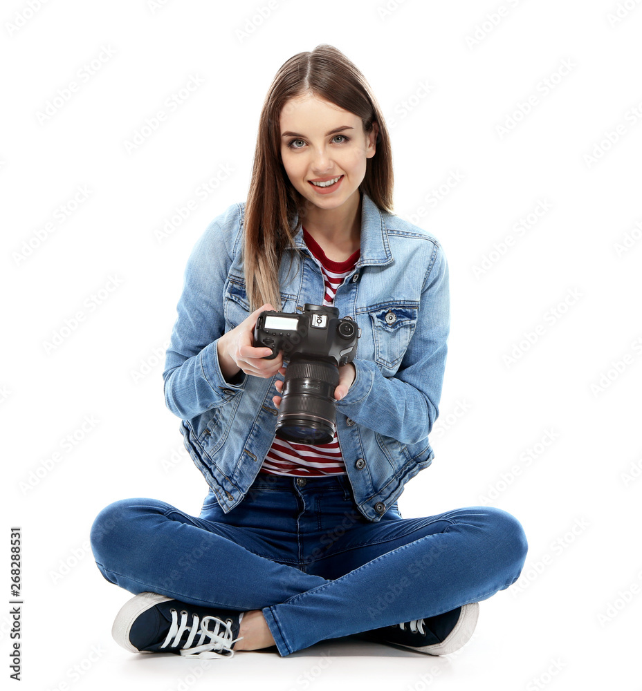 Young female photographer on white background