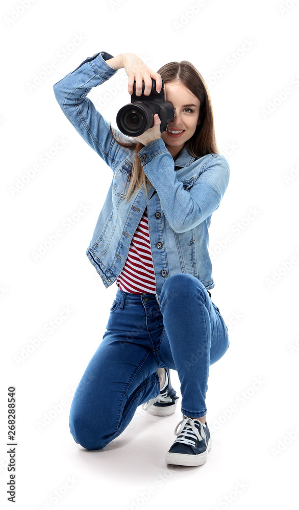 Young female photographer on white background