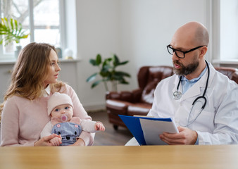 Mother with baby visiting pediatrician