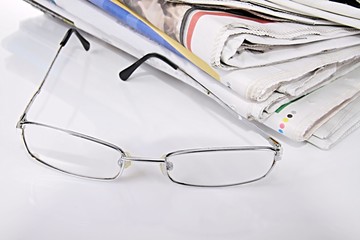 news paper with glasses with white background stock photo