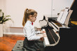 © cherryandbees - cute little girl elegant dressed playing concert piano