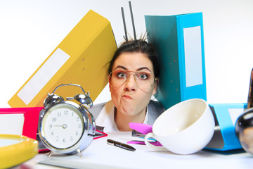 Definetly busy. Young woman getting a lot of work and deadline, being under the pressure of the deals. Pressed by folders with papers. Concept of office worker's troubles, business, problems and