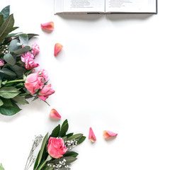 Wall Mural - Flat lay: Bible and pink, red, rose flower bouquet. On white background. Baselland, Switzerland 12.05.2019