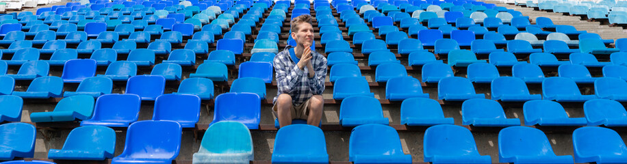 lonely man on the empty stadium seat cheering for the team, one man army concepts