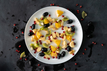 Wall Mural - fresh organic sliced or chopped in a small pieces exotic fruits, garnet, kiwi, bananas