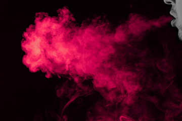 Wall Mural - Portrait of a side mouth part of guys face with a colored backlight of monochrome smoking a vape and exhaling pink in different directions on a black isolated background. Puffs harmful to health.