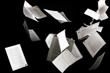 many flying business documents isolated on black background