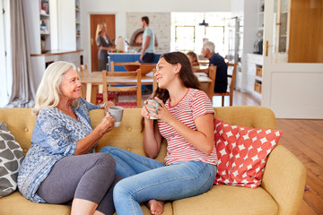 Wall Mural - Grandmother With Teenage Granddaughter Relaxing On Sofa And Talking At Home