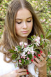 © Iveta - young caucasian woman with healthy skin and hairs stay in apple blossom garden