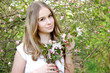 © Iveta - young caucasian woman with healthy skin and hairs stay in apple blossom garden