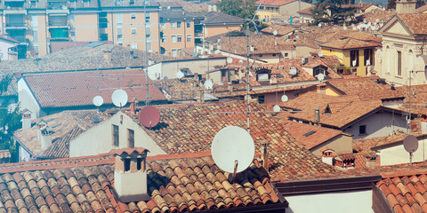 many satellite antennas, view of roofs covered by tv receivers