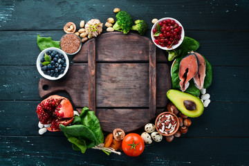 Food for heart health: Fish, blueberries, nuts, pomegranate, avocados, tomatoes, spinach, flax. The concept of healthy eating.