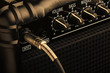 Guitar amplifier with jack plugged in. Close up macro view