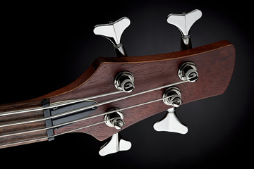 Wall Mural - Maroon electric bass guitar head stock and tuning keys. Close up.