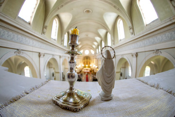 Statue of Virgin Mary and candlestick in church