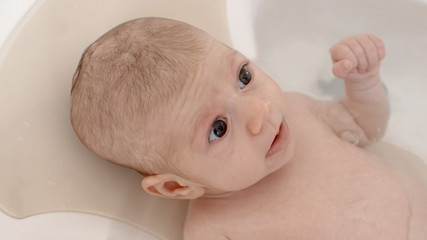 small baby girl having a bath