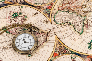 Vintage pocket watch clock on ancient map background