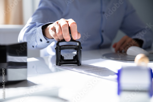 Fotomural Person's Hand Stamping With Approved Stamp