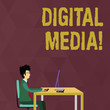 © Artur - Writing note showing Digital Media. Business concept for digitized content that can be transmitted over the internet Businessman Sitting on Chair Working on Computer and Books