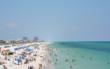 Fototapeta  - Beach goers at Pensacola Beach in Escambia County, Florida on the Gulf of Mexico, USA