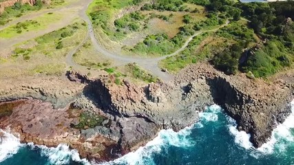 Wall Mural - Natural rock formations of basalt columns on the Australian coastline of an ancient Bombo quarry